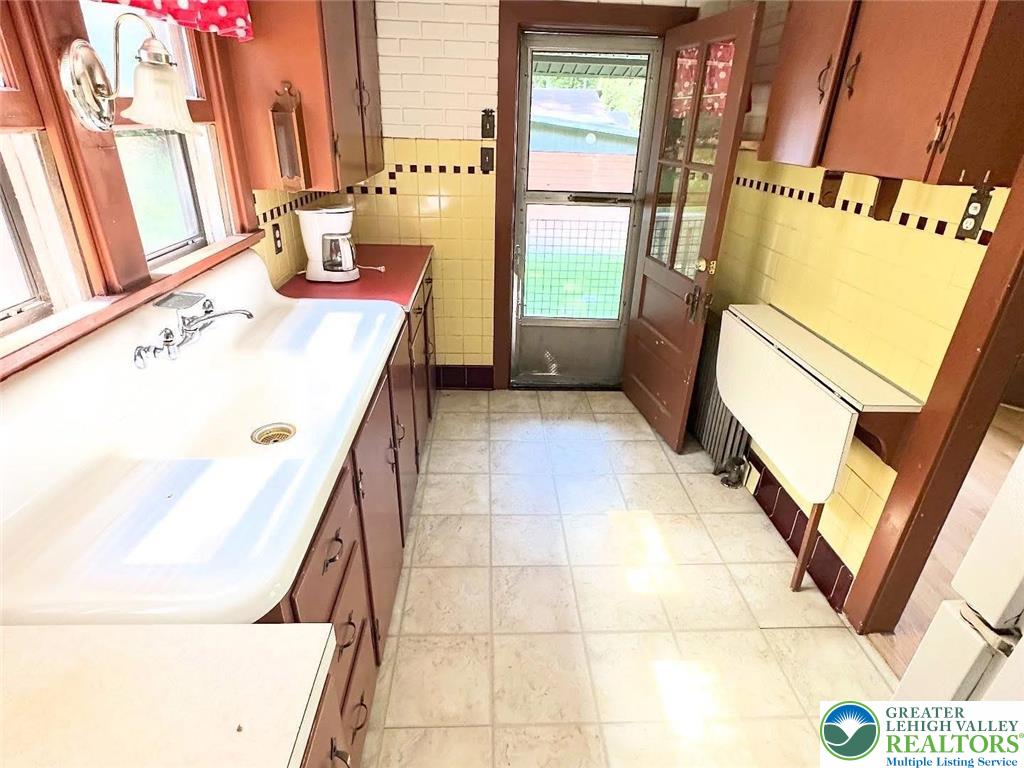 4024 South 2nd Street Emmaus, PA 18049 - Photo 8 of 19 a bathroom with a granite countertop sink and a mirror