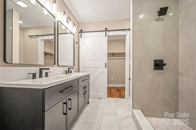 a bathroom with a double vanity sink a mirror and a shower