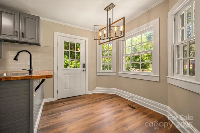 a view of a kitchen with a sink and wooden floor