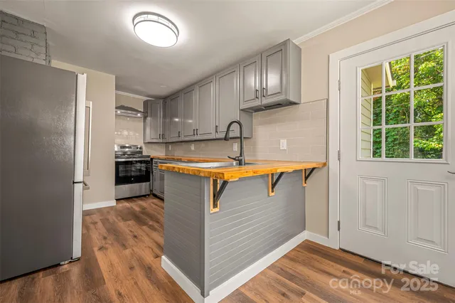 a view of a kitchen with electric appliances