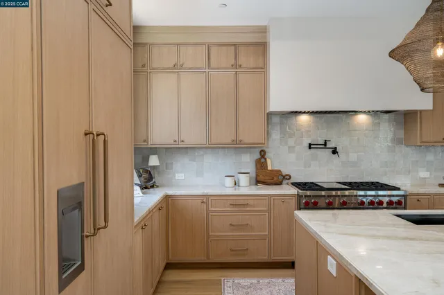 a kitchen with a sink a stove and cabinets