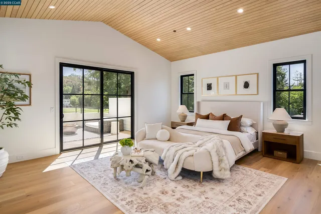 a view of a patio with table and chairs with wooden floor and fence