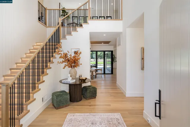 a living room with furniture a fireplace and a chandelier