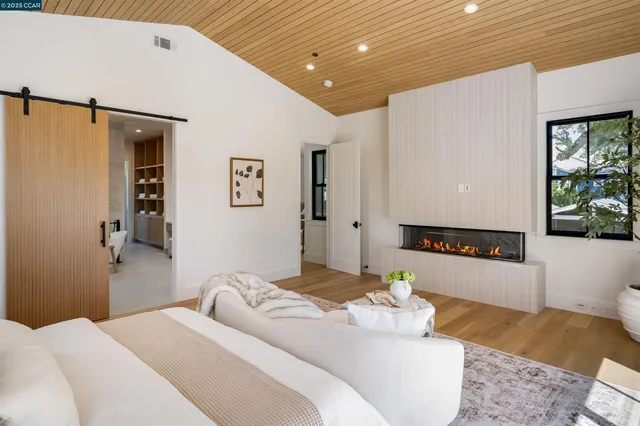 a bedroom with a bed and a potted plant