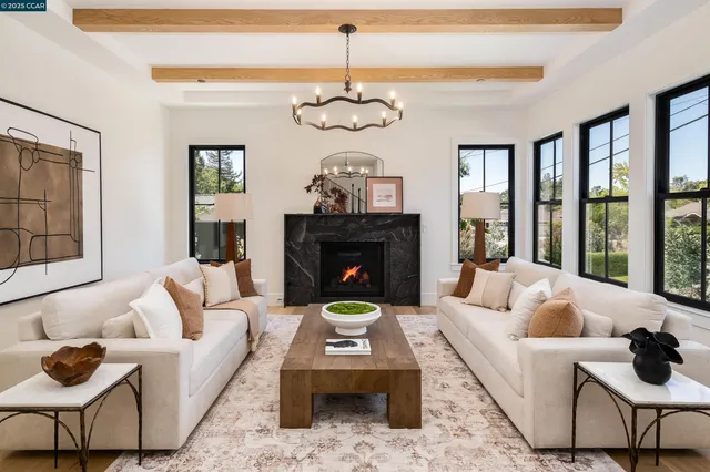 a living room with furniture a fireplace and a table