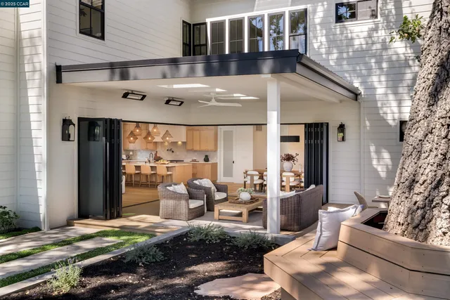 a view of a house with backyard and sitting area