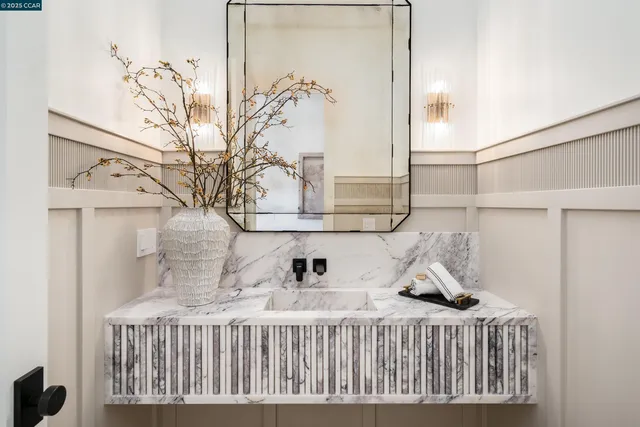 a dining room with furniture a chandelier and wooden floor