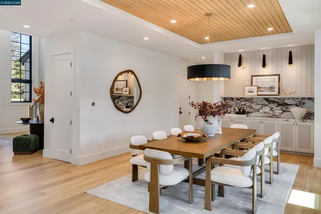 a view of a dining room with furniture wooden floor and a chandelier