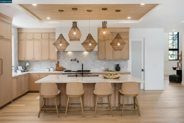a kitchen with stainless steel appliances a table chairs and a chandelier