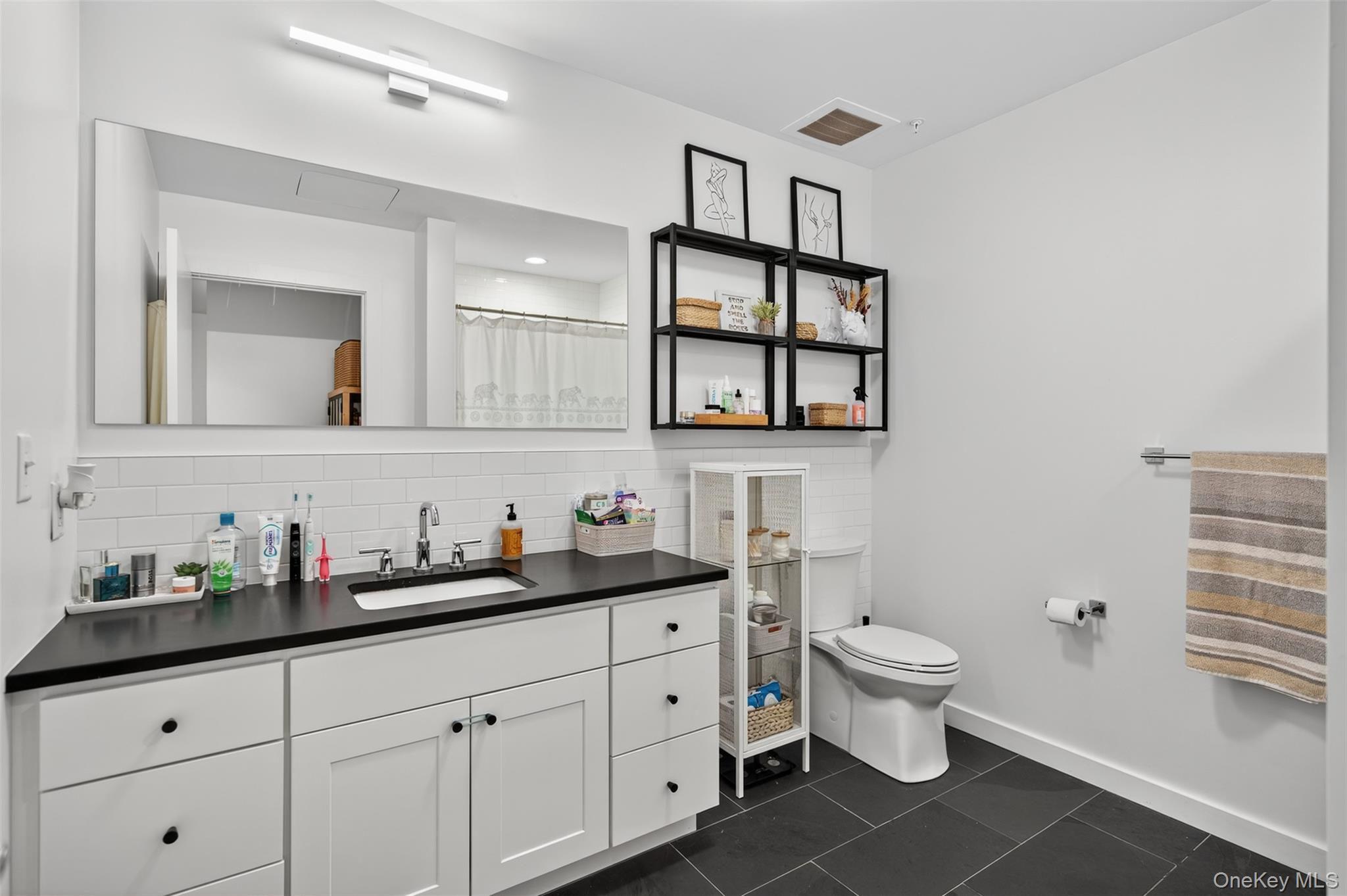 249 Main Street, Unit 305 Beacon, NY 12508 - Photo 16 of 36 Full bath with tasteful backsplash, vanity, a shower with shower curtain, and dark tile patterned flooring