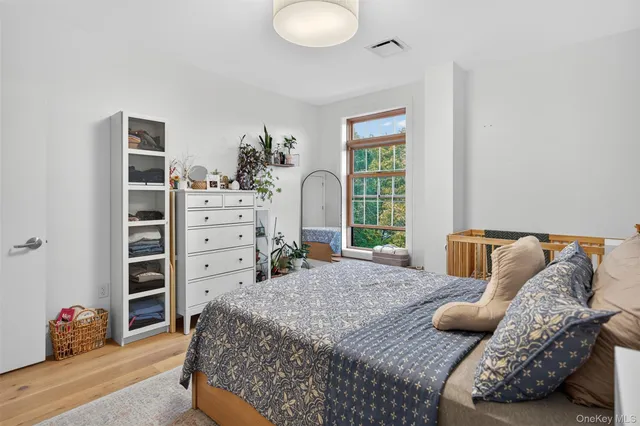 a bedroom with a large bed and a window