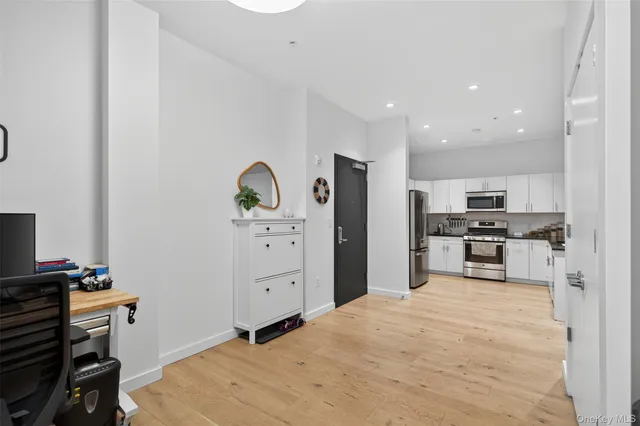 a kitchen with stainless steel appliances kitchen island granite countertop a refrigerator and a stove top oven