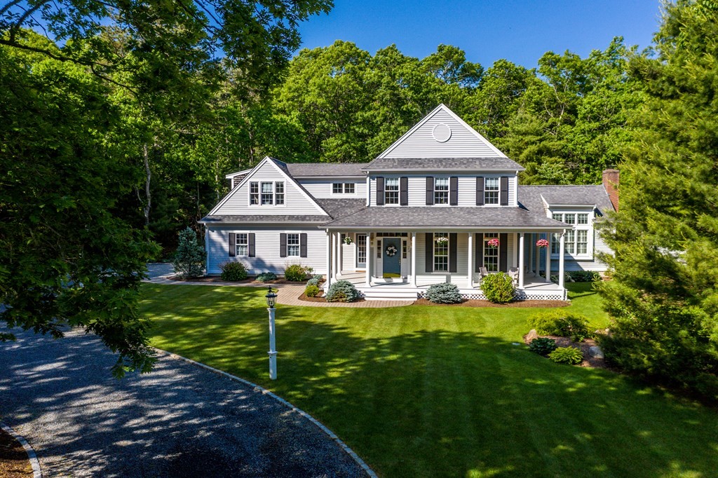 a front view of a house with yard and green space