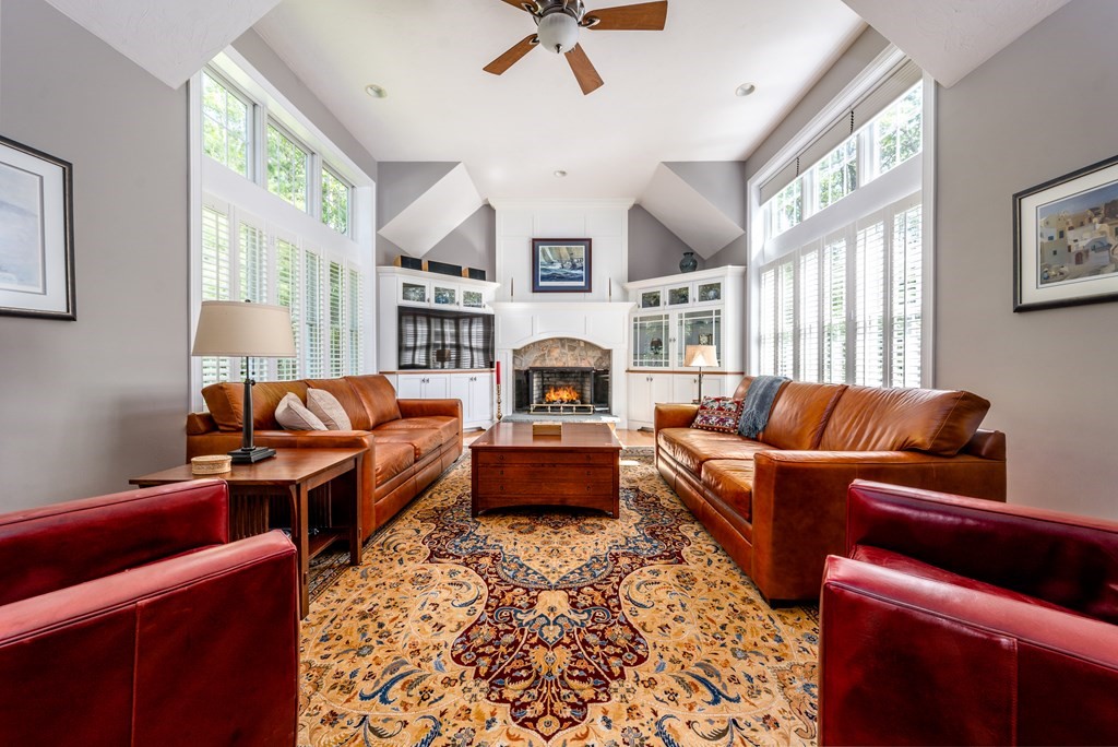 24 Miller Farm Road Mashpee, MA 02649 - Photo 11 of 28 a living room with furniture fireplace and a large window