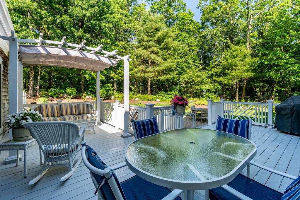 24 Miller Farm Road Mashpee, MA 02649 - Photo 14 of 28 a view of a table and chairs in the patio
