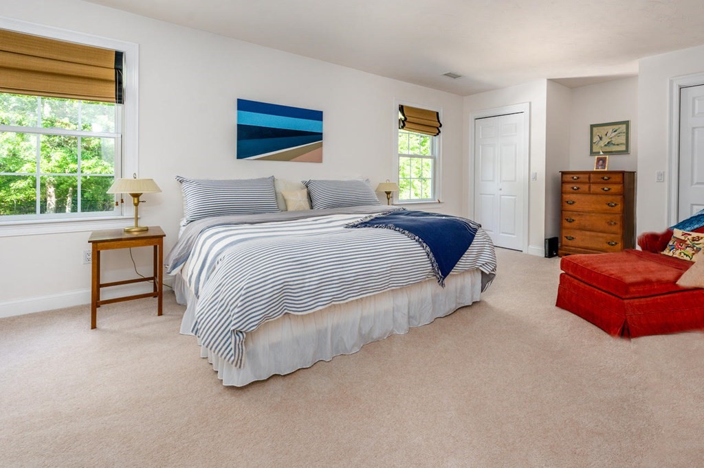 24 Miller Farm Road Mashpee, MA 02649 - Photo 18 of 28 a spacious bedroom with a bed and a couch