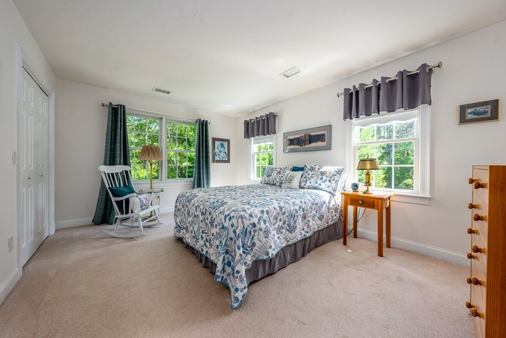 24 Miller Farm Road Mashpee, MA 02649 - Photo 20 of 28 a bedroom with a bed and a large window