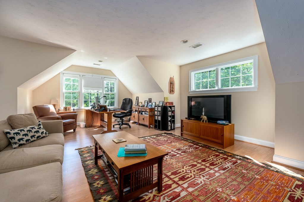24 Miller Farm Road Mashpee, MA 02649 - Photo 23 of 28 a living room with furniture and a fireplace