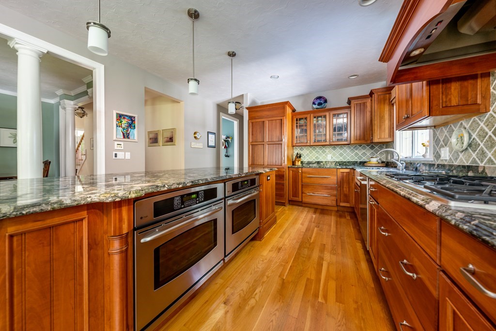 24 Miller Farm Road Mashpee, MA 02649 - Photo 8 of 28 a large kitchen with stainless steel appliances granite countertop a stove and a sink