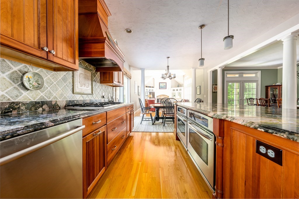 24 Miller Farm Road Mashpee, MA 02649 - Photo 10 of 28 a large kitchen with stainless steel appliances granite countertop a lot of counter space and a wooden floor