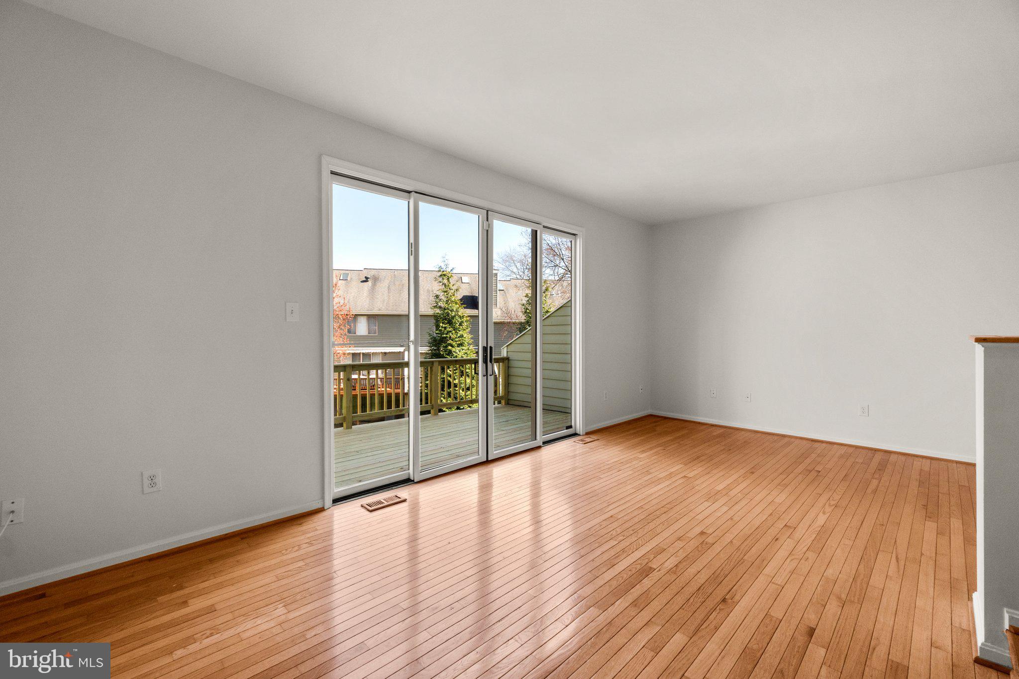 5269 Columbia Road, Unit 4 89 Columbia, MD 21044 - Photo 3 of 50 Living Room with Sliders to Deck