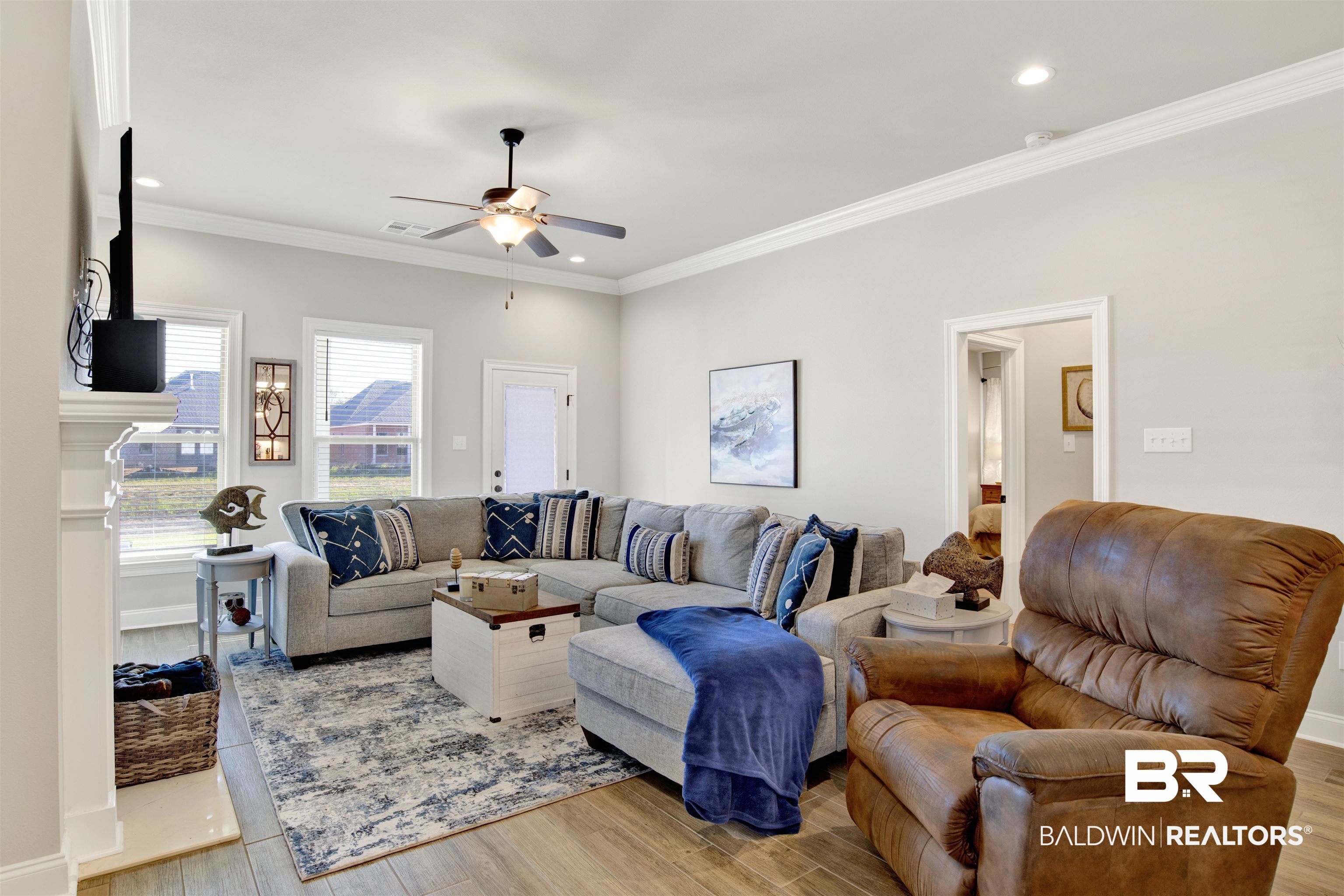 1406 Aldon Street Foley, AL 36535 - Photo 8 of 30 Living room featuring luxury wood-look tile flooring, ceiling fan, and crown molding.