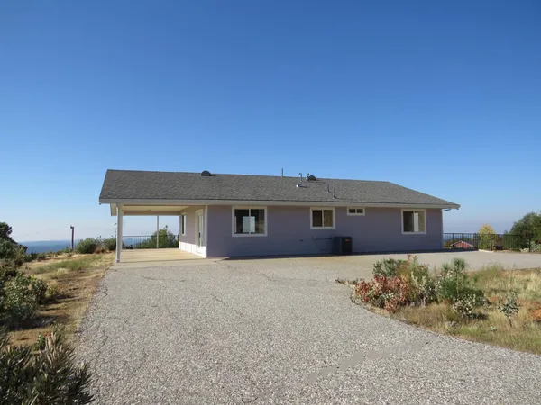 a kitchen with stainless steel appliances granite countertop a sink a stove a microwave cabinets and wooden floor