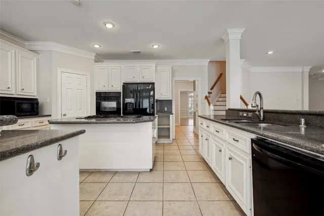 a large kitchen with stainless steel appliances lots of counter space and a sink