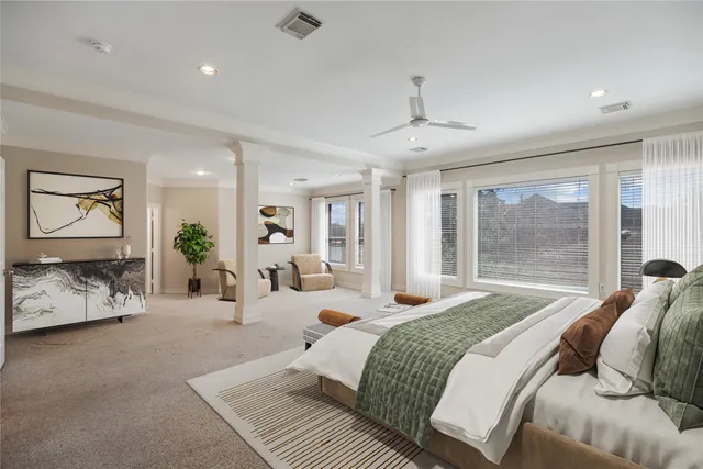 a large bedroom with a large bed couch and a window