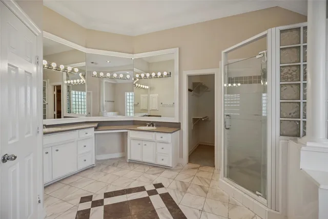 a large bathroom with a granite countertop sink a mirror and a shower