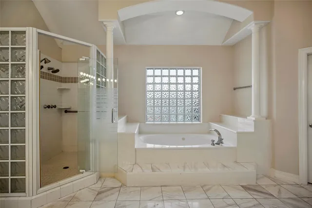 a spacious bathroom with a bathtub and shower