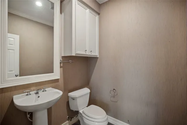 a bathroom with a sink a toilet and mirror