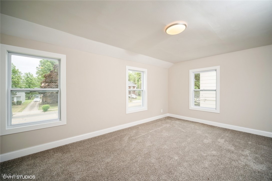 2188 North Taylor Road Cleveland Heights, OH 44112 - Photo 10 of 15 Carpeted spare room featuring baseboards and vaulted ceiling