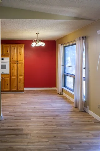 a view of a room with wooden floor and window