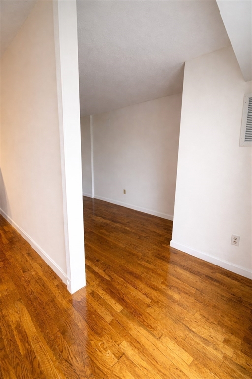 133 Commander Shea Boulevard, Unit 709 Quincy, MA 02171 - Photo 10 of 16 a view of empty room with wooden floor