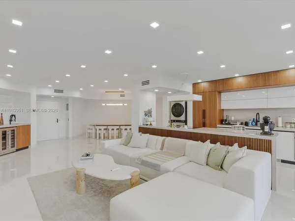 a large living room with stainless steel appliances