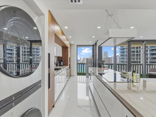 a kitchen with a sink and a stove top oven
