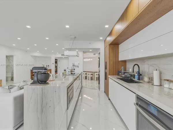a kitchen with a sink and a stove top oven