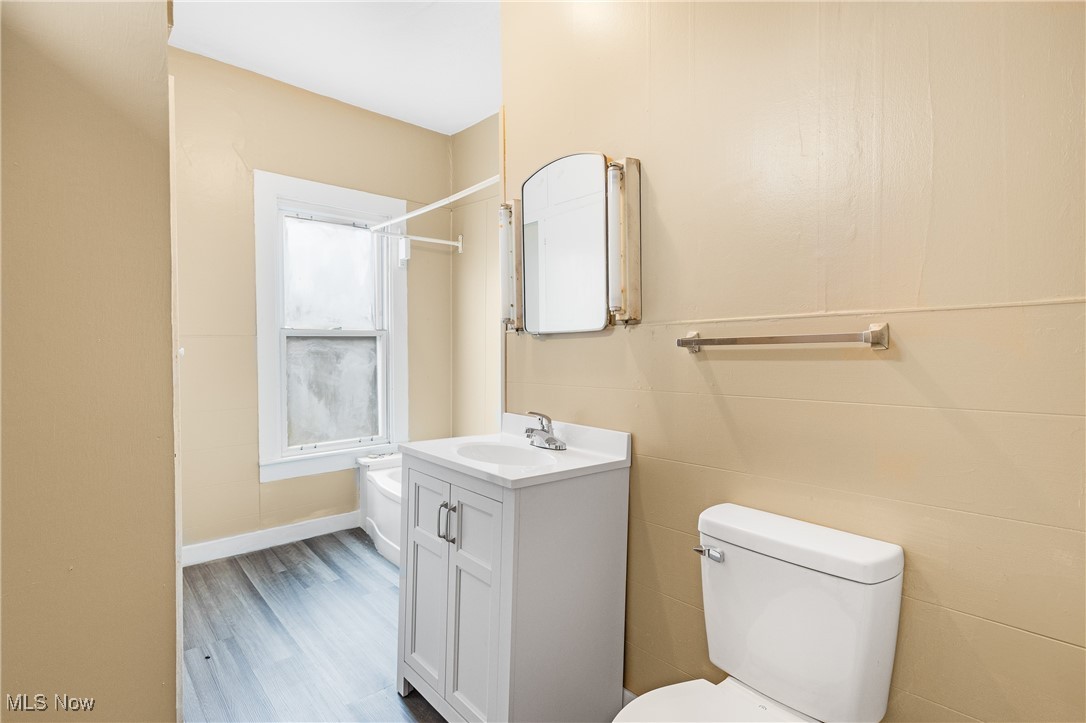 7529 State Line Burghill, OH 44404 - Photo 18 of 23 Full bath with vanity, shower combination, and wood finished floors
