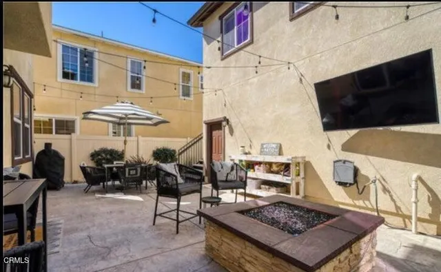 a view of a chairs and table in the backyard
