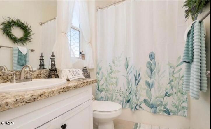 3431 North Oxnard Boulevard, Unit B Oxnard, CA 93036 - Photo 8 of 15 a bathroom with a granite countertop sink and a toilet