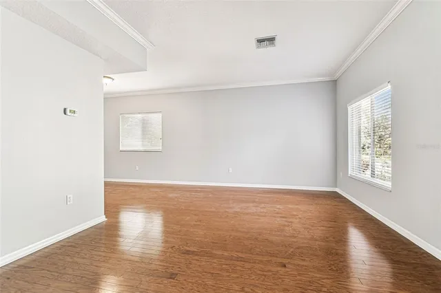 a view of a living room with furniture and wooden floor