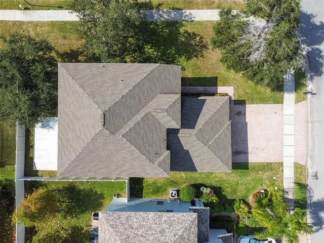 an aerial view of a house with yard