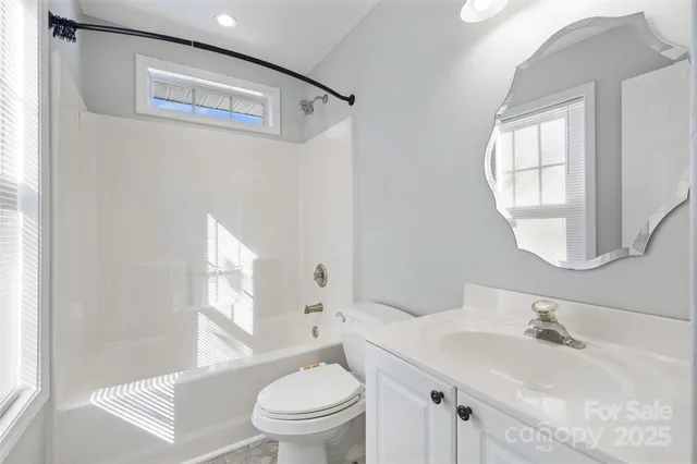 a bathroom with a sink toilet and a mirror