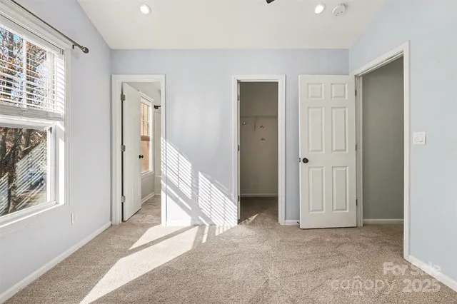 a view of a livingroom with wooden floor and windows