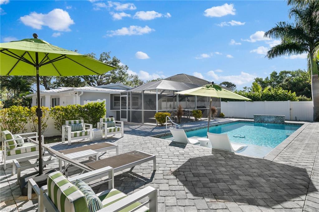 2270 Harbor Road Naples, FL 34104 - Photo 18 of 21 a view of a patio with a table and chairs under an umbrella