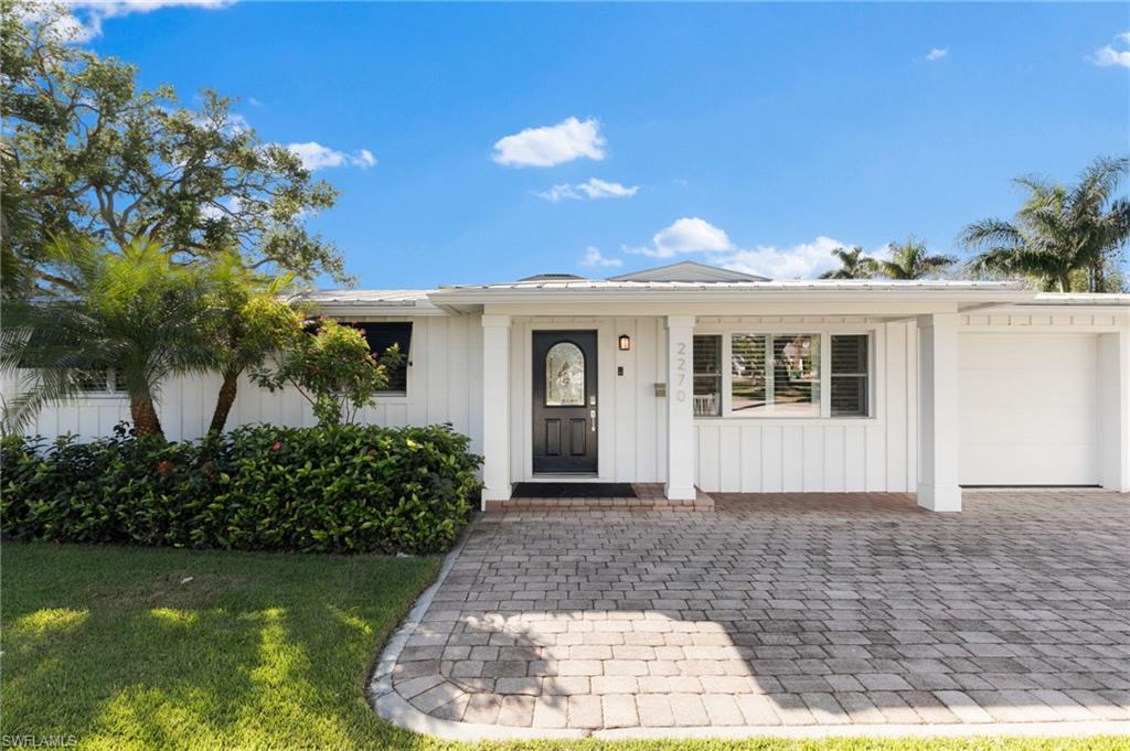2270 Harbor Road Naples, FL 34104 - Photo 20 of 21 a front view of a house with a garden