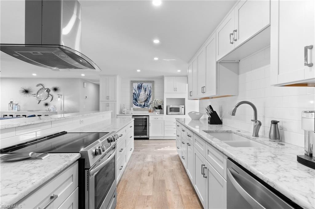 2270 Harbor Road Naples, FL 34104 - Photo 4 of 21 a large kitchen with stainless steel appliances granite countertop a lot of counter space and wooden floor