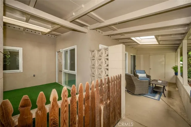 a bedroom with furniture and a large window