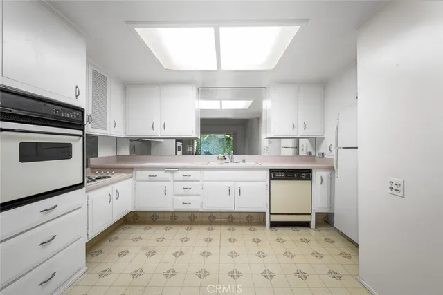 a kitchen with sink cabinets and window